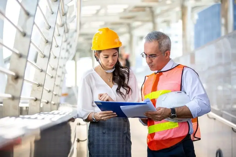 An engineer and an architect reviewing construction documents together